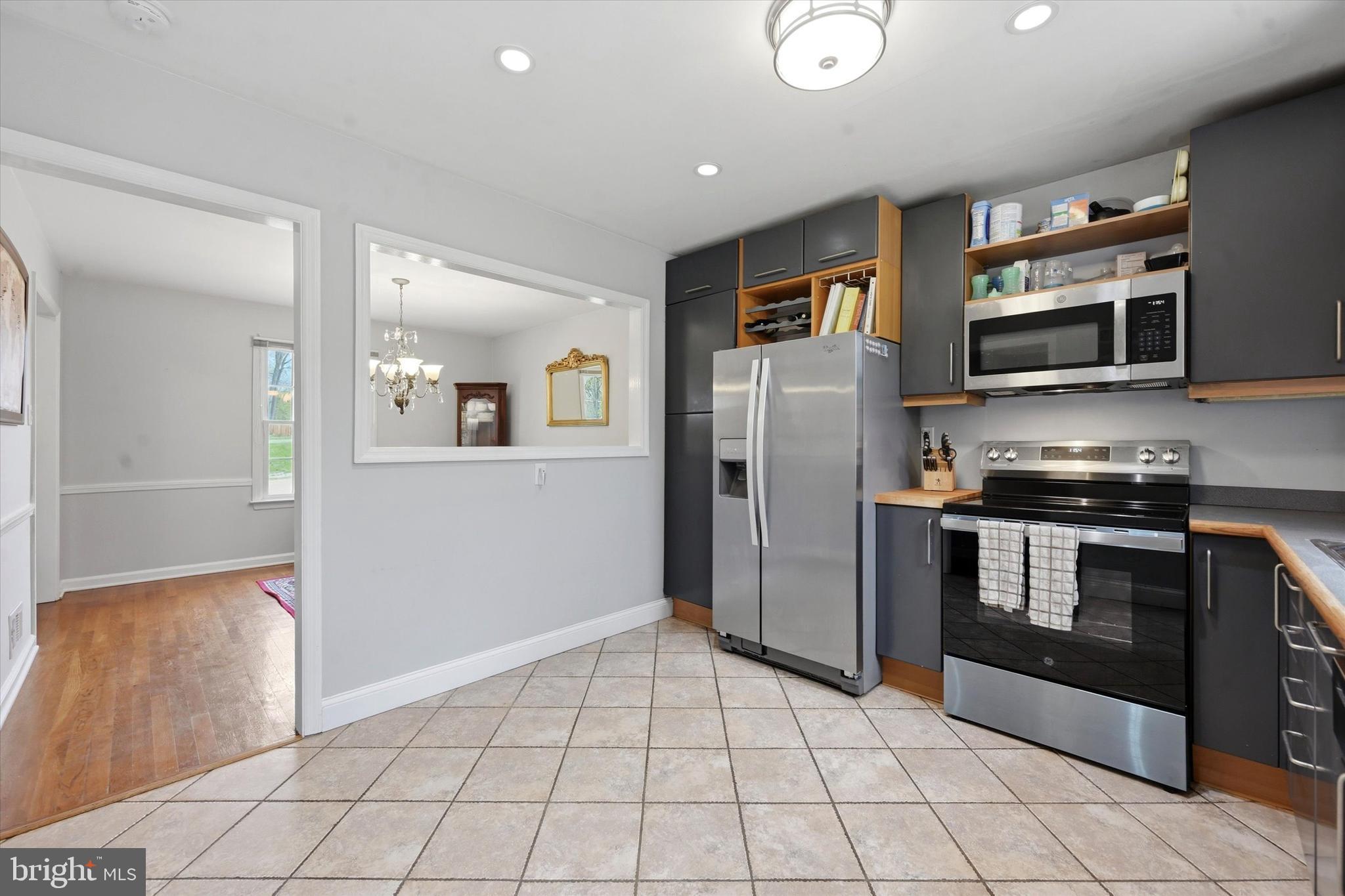 3 South Dillwyn Road Newark, DE 19711 - Photo 12 of 59 a kitchen with stainless steel appliances granite countertop a refrigerator and a stove top oven