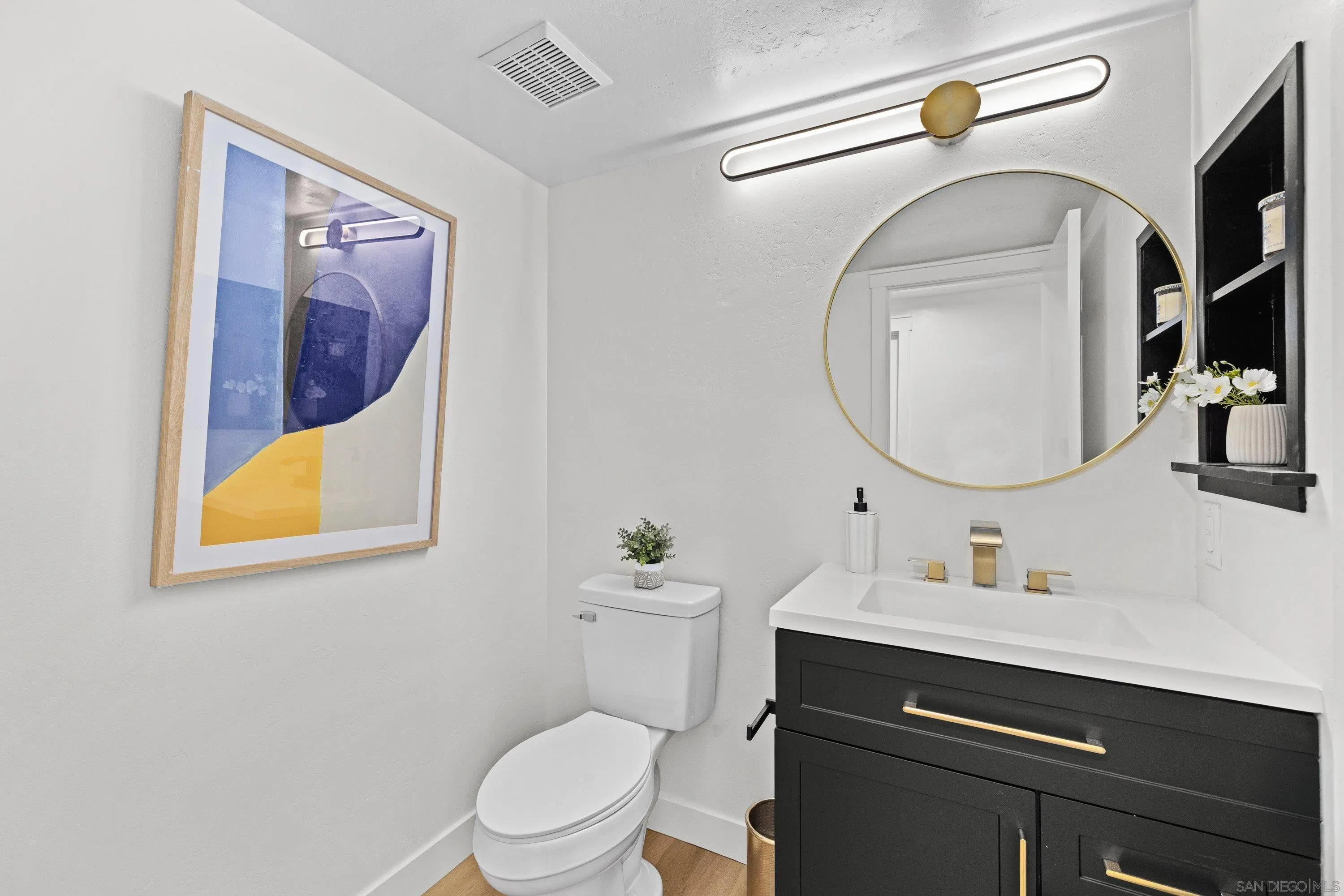4422 Point Degada Oceanside, CA 92058 - Photo 19 of 57 a bathroom with a toilet a sink and mirror