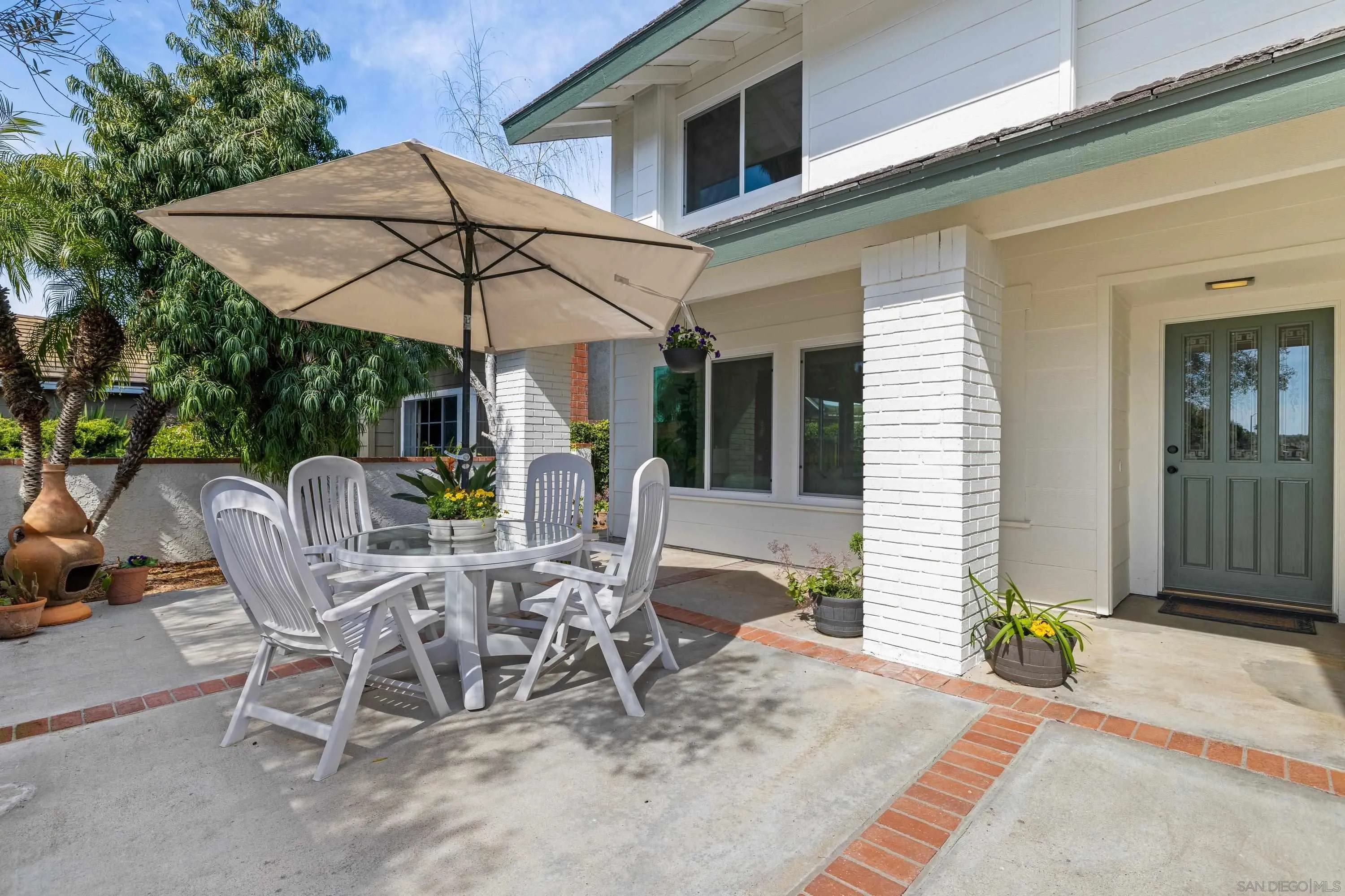 4422 Point Degada Oceanside, CA 92058 - Photo 2 of 57 a view of a patio with a table and chairs under an umbrella