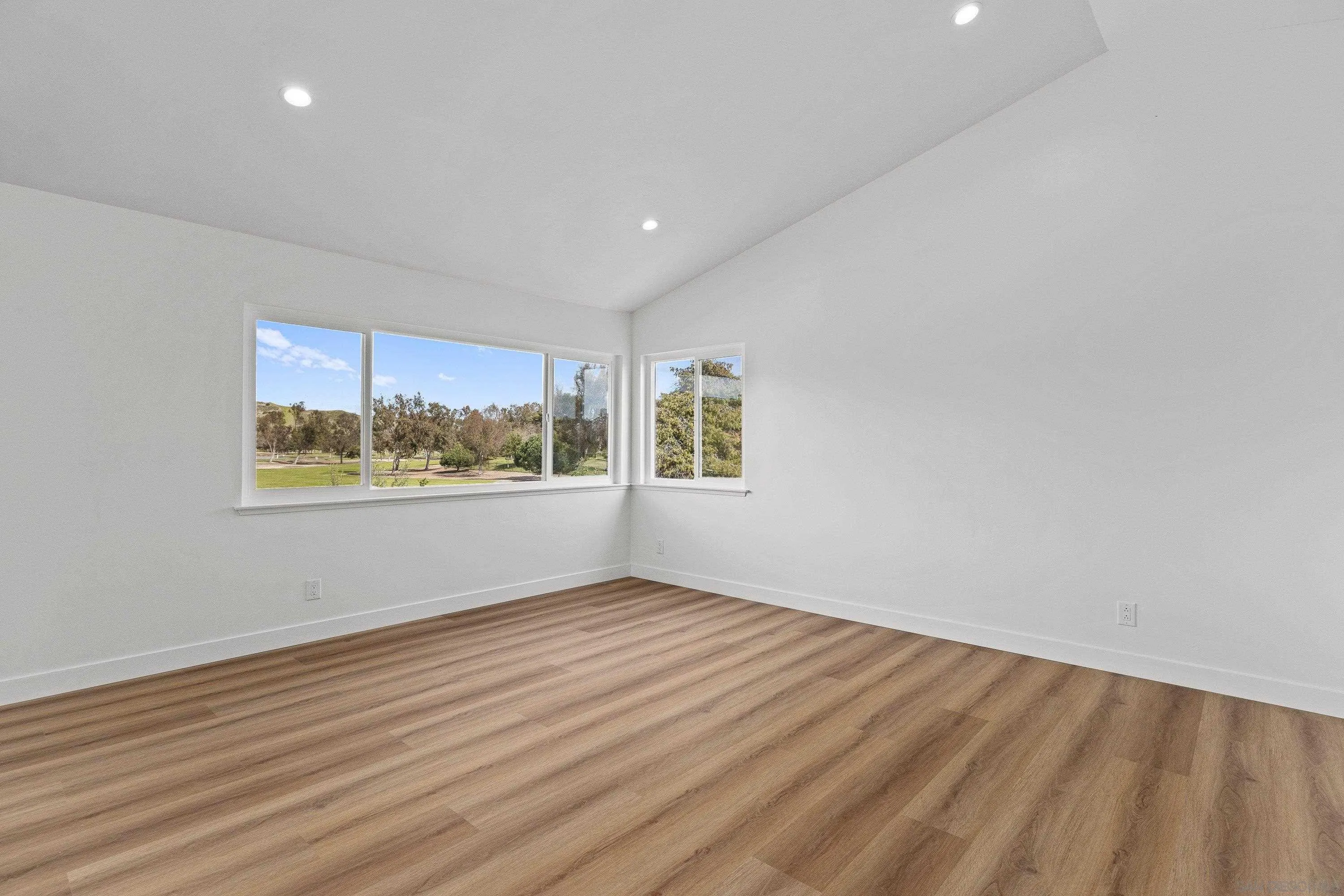 4422 Point Degada Oceanside, CA 92058 - Photo 21 of 57 a view of an empty room with wooden floor and a window