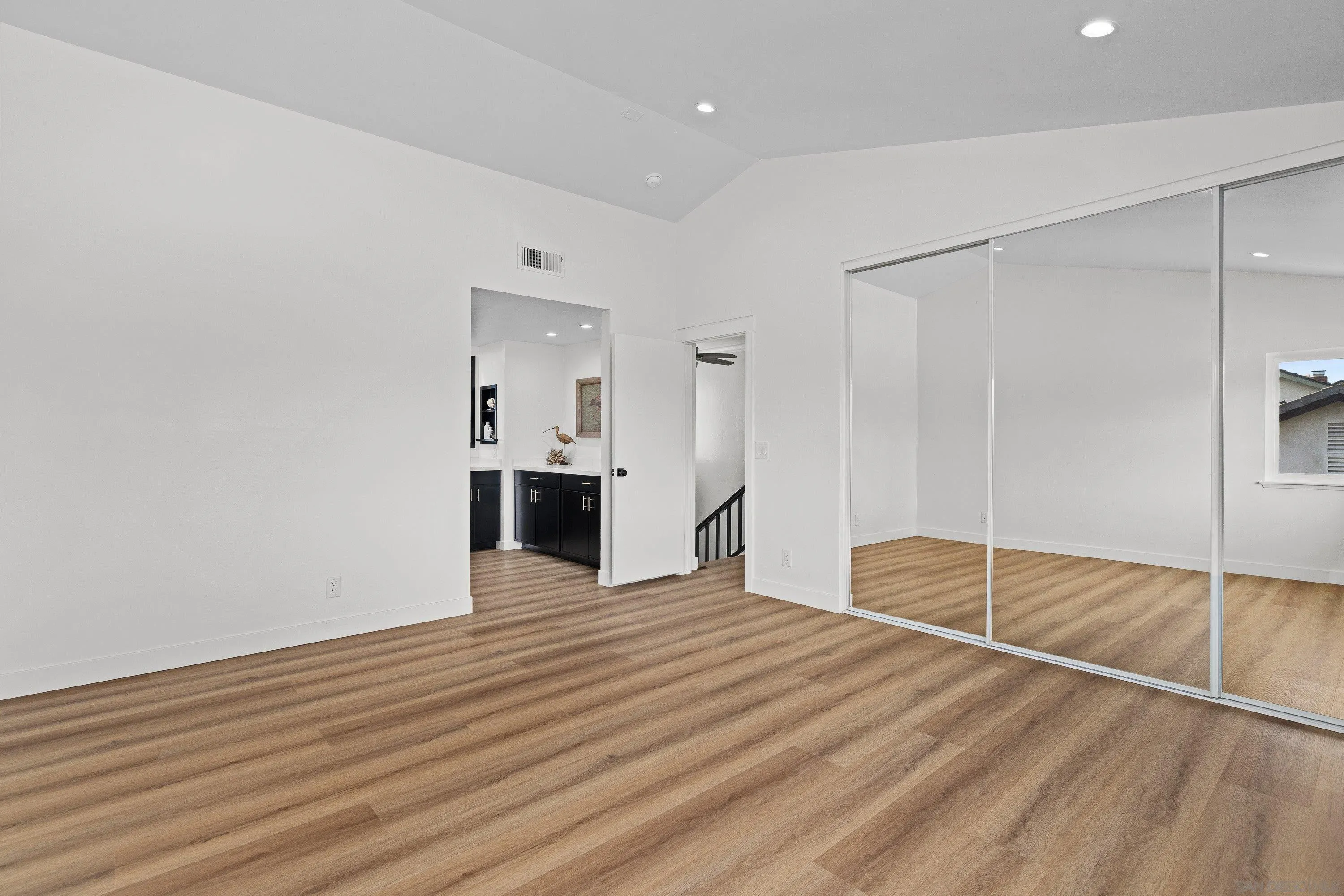 4422 Point Degada Oceanside, CA 92058 - Photo 22 of 57 a view of empty room with wooden floor and kitchen
