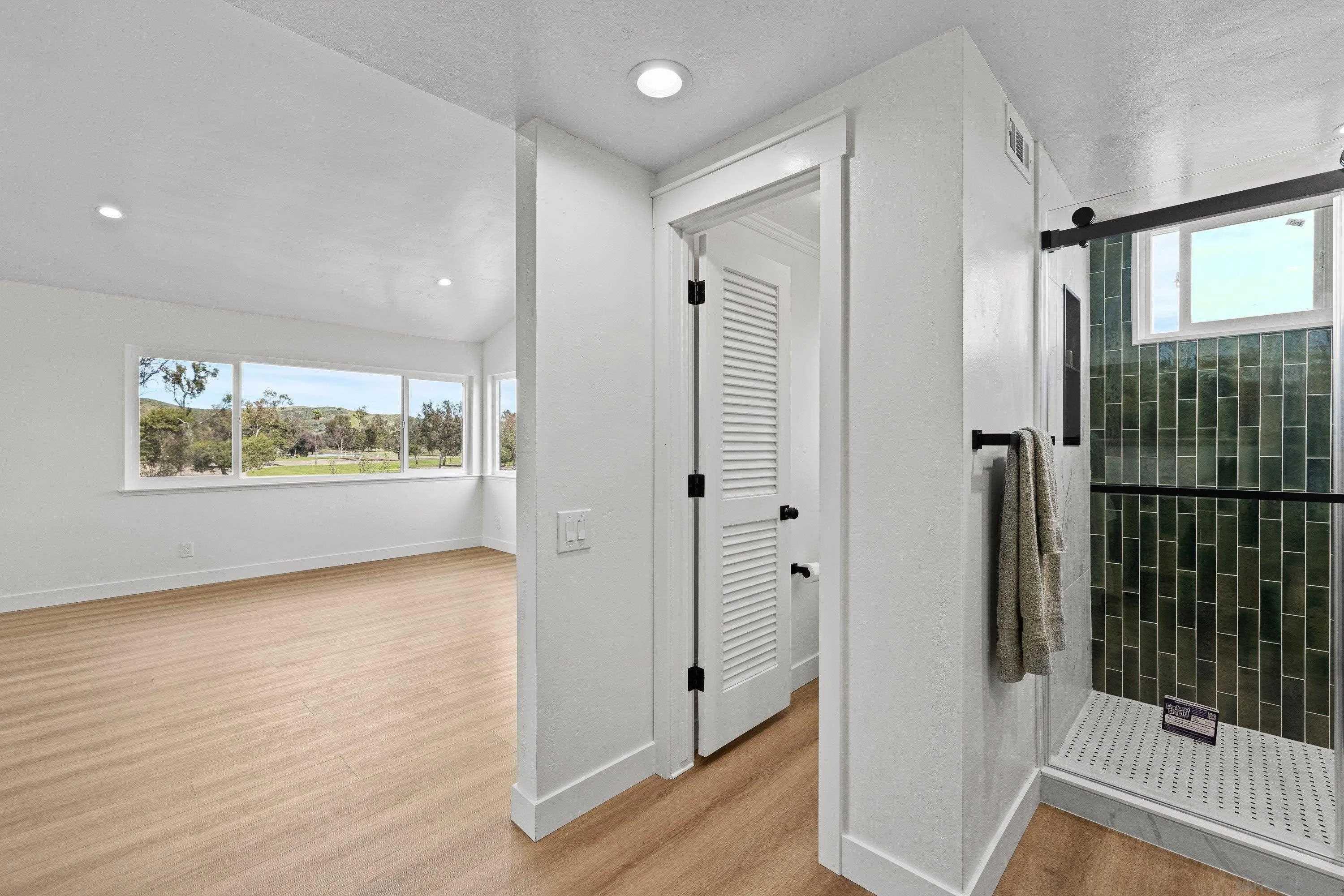 4422 Point Degada Oceanside, CA 92058 - Photo 28 of 57 a view of a hallway with wooden floor and glass door
