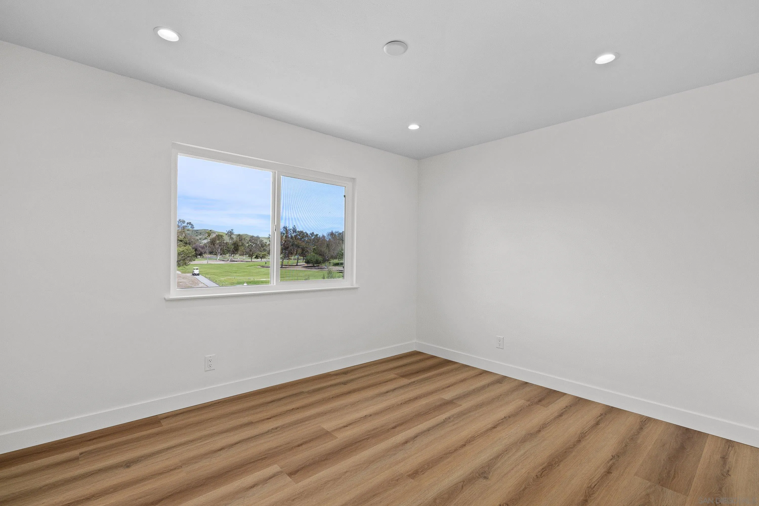 4422 Point Degada Oceanside, CA 92058 - Photo 37 of 57 a view of empty room with wooden floor and fan