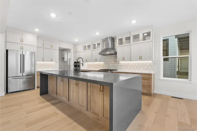 a kitchen with stainless steel appliances granite countertop a refrigerator sink and cabinets