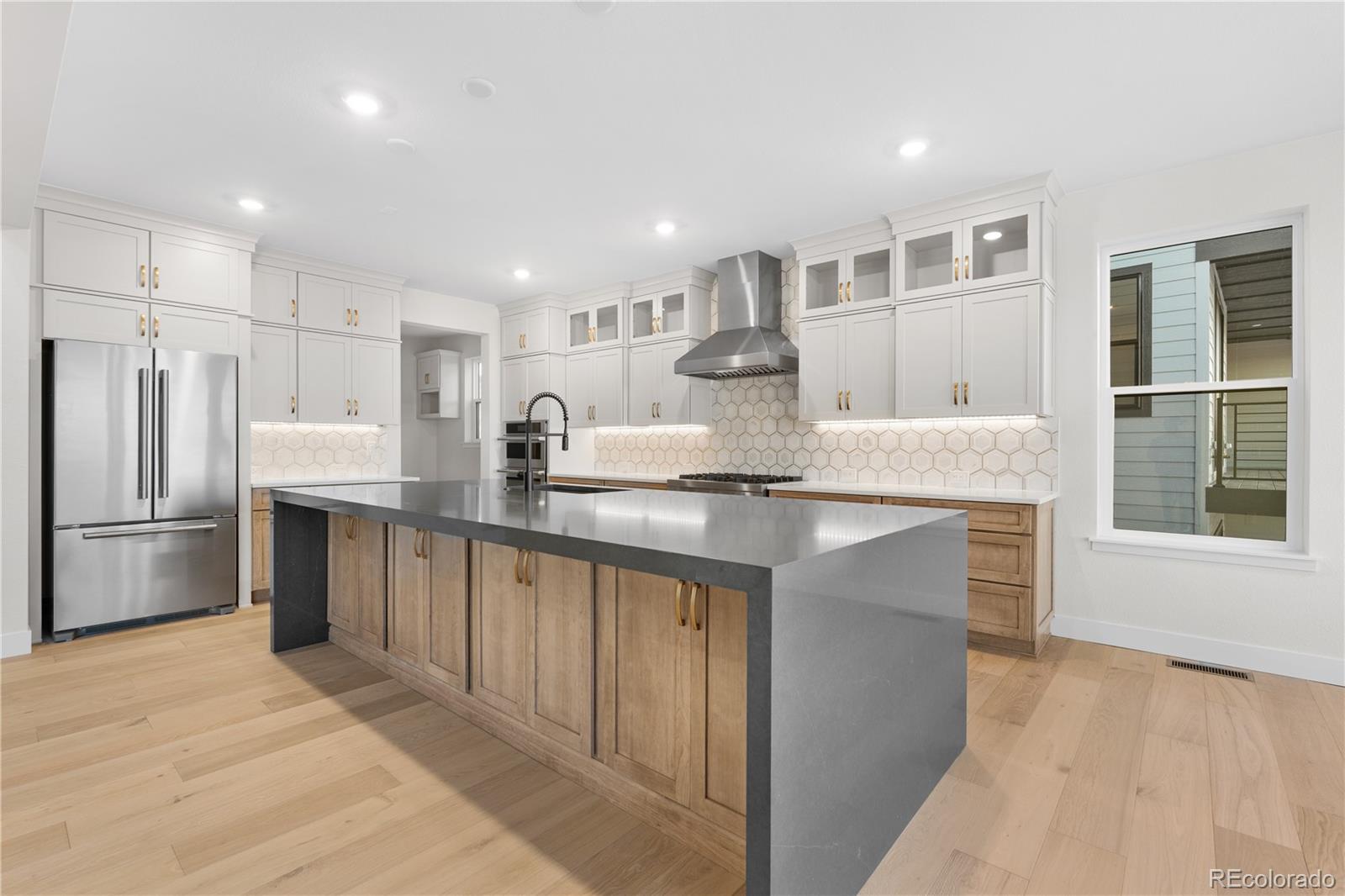 11283 Tenor Trail Lone Tree, CO 80134 - Photo 15 of 47 a kitchen with stainless steel appliances granite countertop a refrigerator sink and cabinets