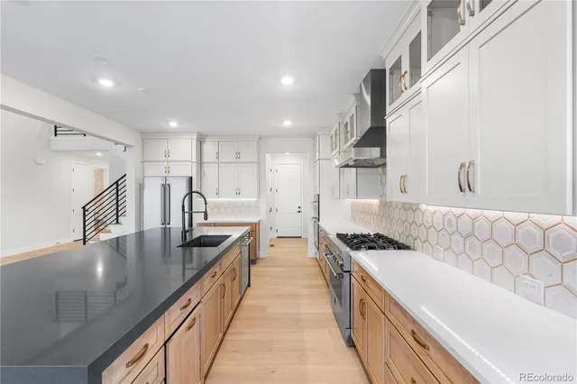 a kitchen with stainless steel appliances granite countertop a sink and cabinets