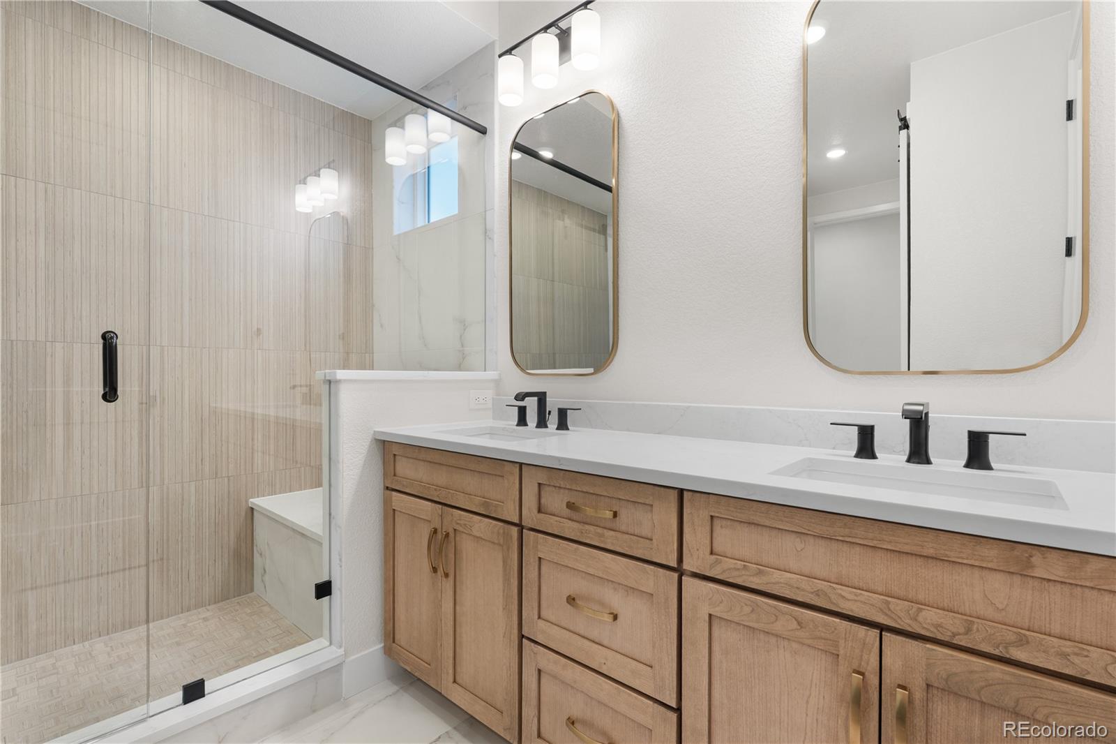 11283 Tenor Trail Lone Tree, CO 80134 - Photo 23 of 47 a bathroom with a double vanity sink mirror and shower