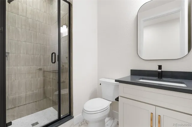 a bathroom with a sink toilet and a mirror