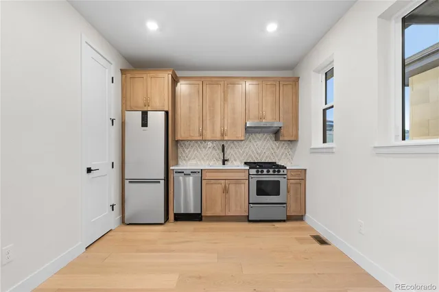 a kitchen with a stove top oven sink and cabinets