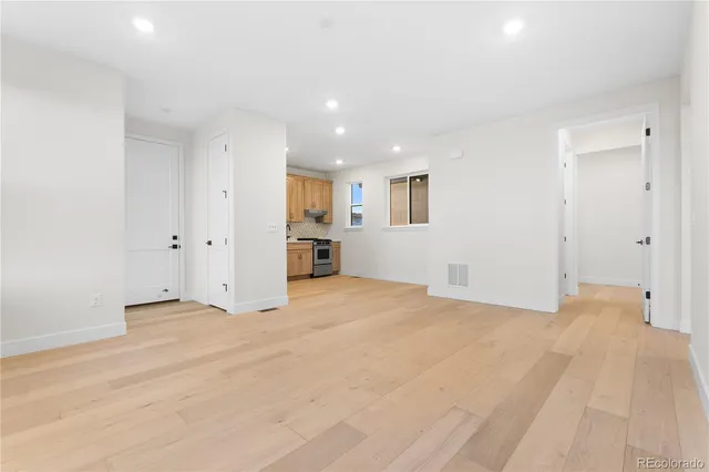 a view of an empty room with closet and a window