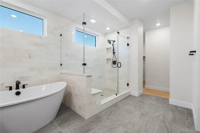 a bathroom with a bathtub and shower