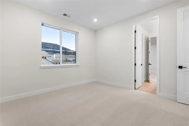 an empty room with windows and closet