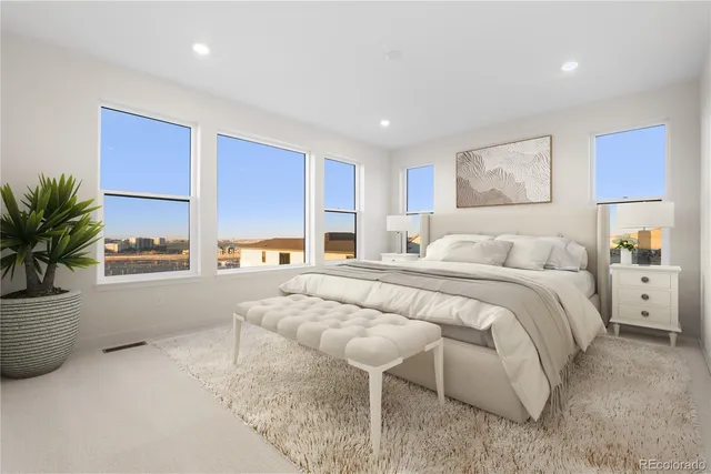 a spacious bedroom with a large bed and a couch