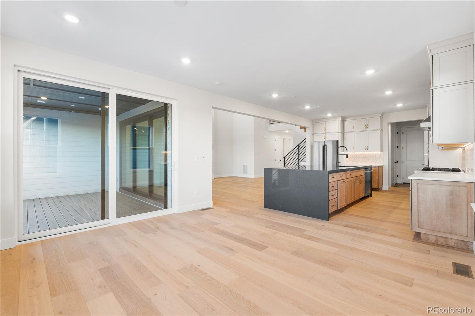 11283 Tenor Trail Lone Tree, CO 80134 - Photo 4 of 47 a large kitchen with stainless steel appliances kitchen island a large counter top and a refrigerator