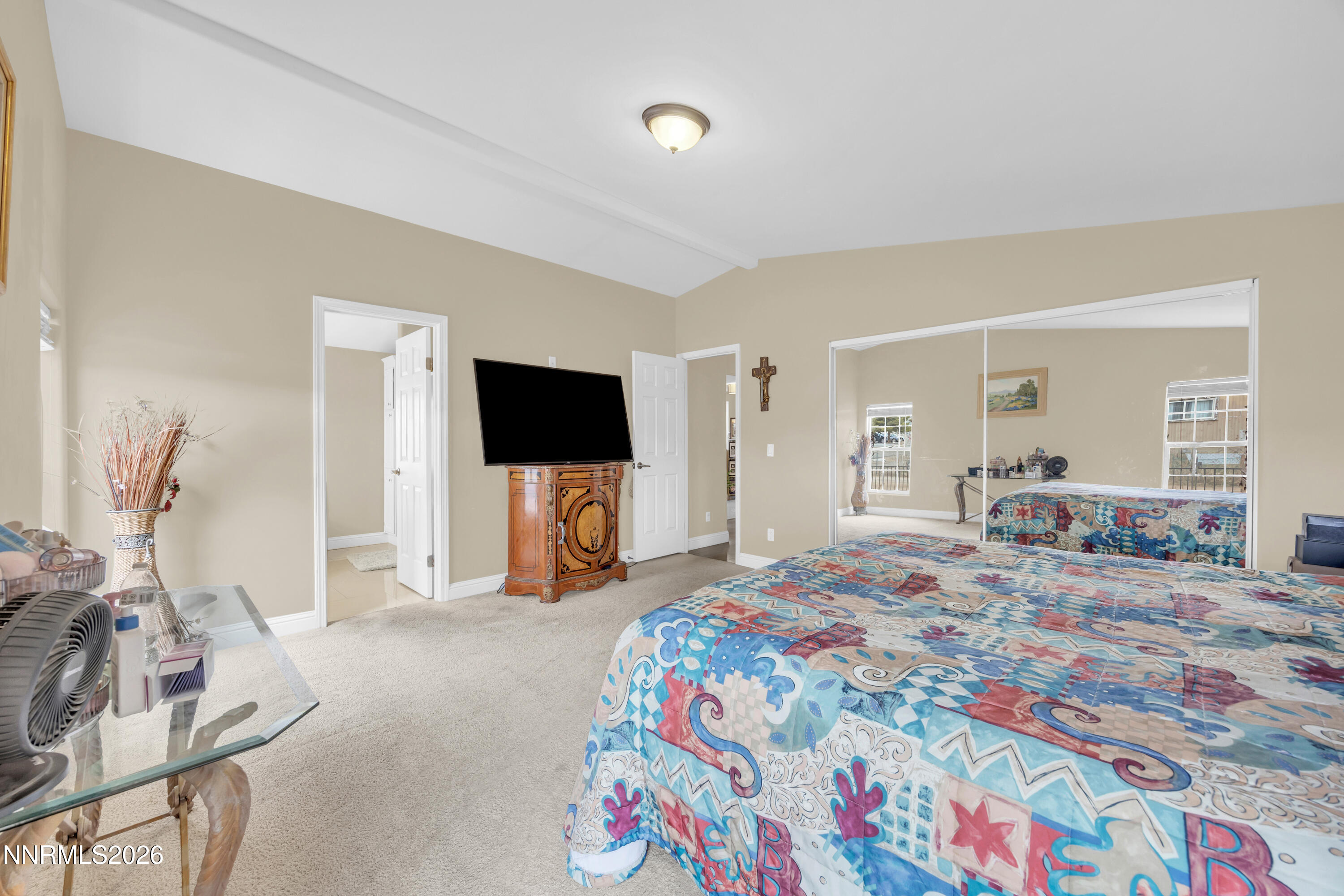 592 Morgan Circle Sun Valley, NV 89433 - Photo 14 of 24 a bedroom with a bed and a flat tv screen on dresser