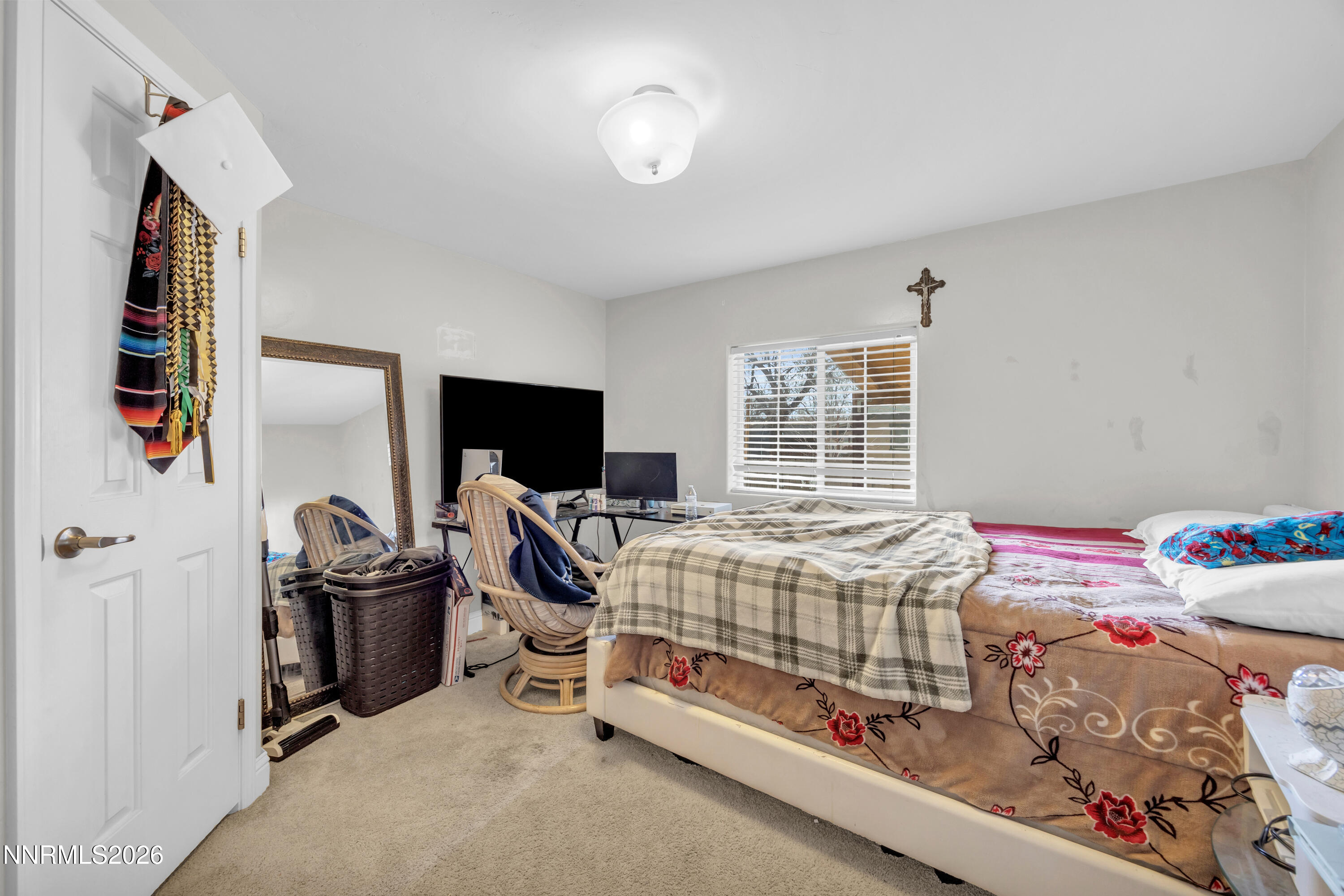 592 Morgan Circle Sun Valley, NV 89433 - Photo 17 of 24 a bedroom with a bed and a flat tv screen on the dresser