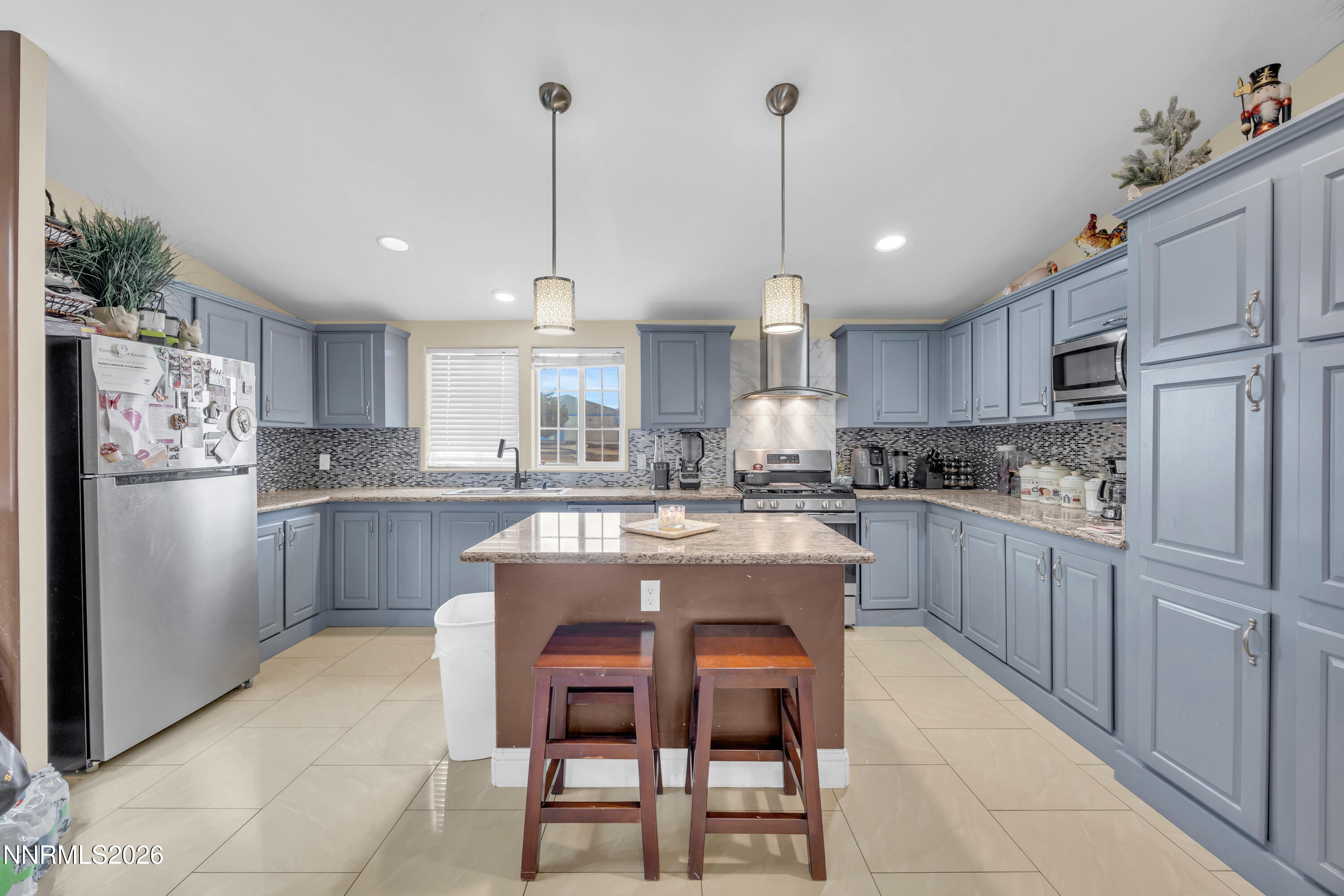 592 Morgan Circle Sun Valley, NV 89433 - Photo 9 of 24 a kitchen with kitchen island white cabinets and stainless steel appliances