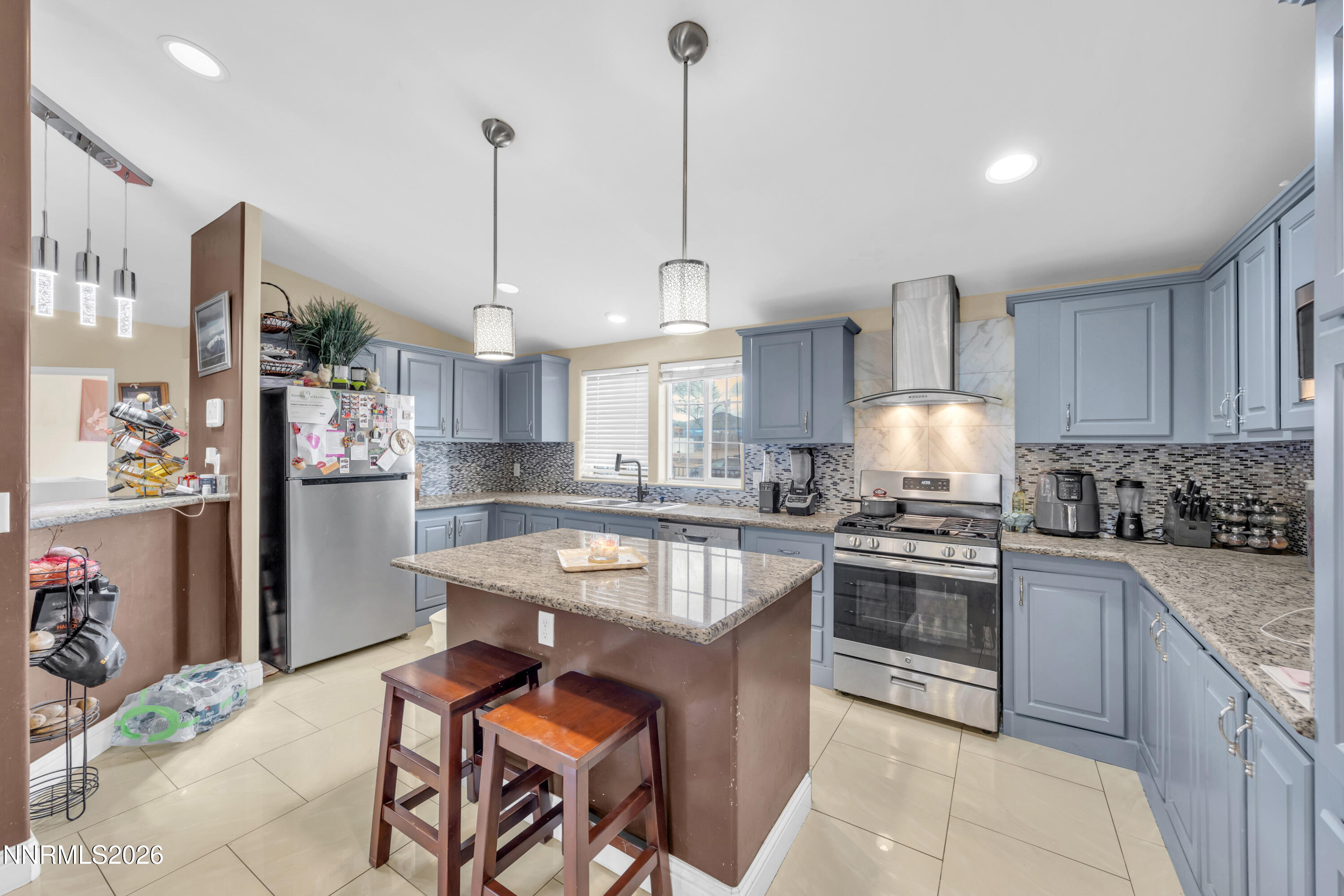 592 Morgan Circle Sun Valley, NV 89433 - Photo 10 of 24 a kitchen with stainless steel appliances granite countertop a stove top oven a refrigerator a sink and dishwasher