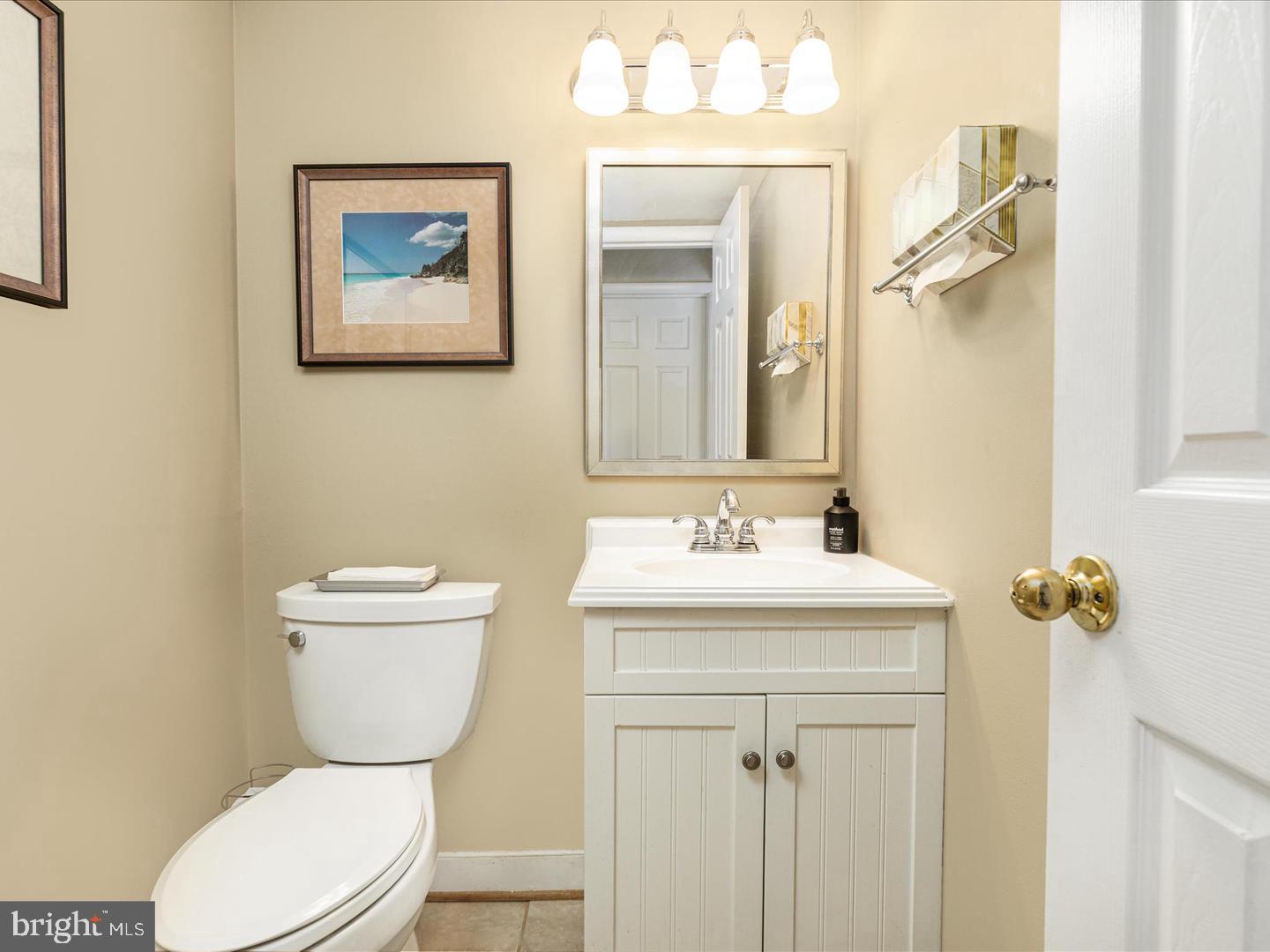 6434 Rives Court Springfield, VA 22150 - Photo 16 of 37 a bathroom with a toilet sink and mirror