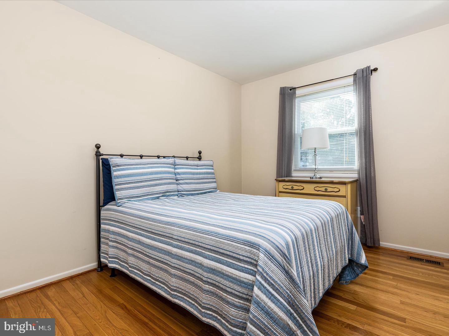 6434 Rives Court Springfield, VA 22150 - Photo 19 of 37 a bedroom with a bed and wooden floor