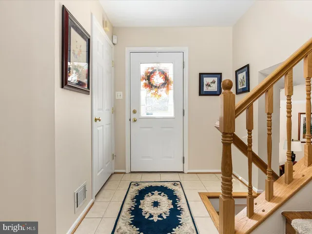 a view of a hallway with wooden floor and stairs