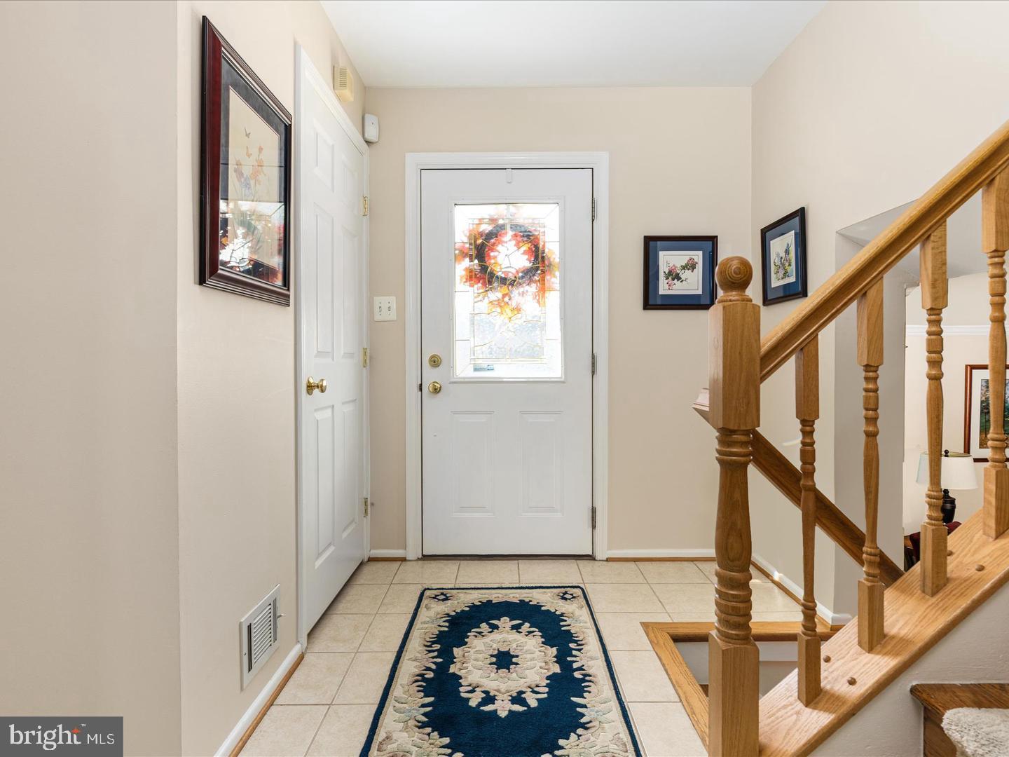 6434 Rives Court Springfield, VA 22150 - Photo 2 of 37 a view of a hallway with wooden floor and stairs