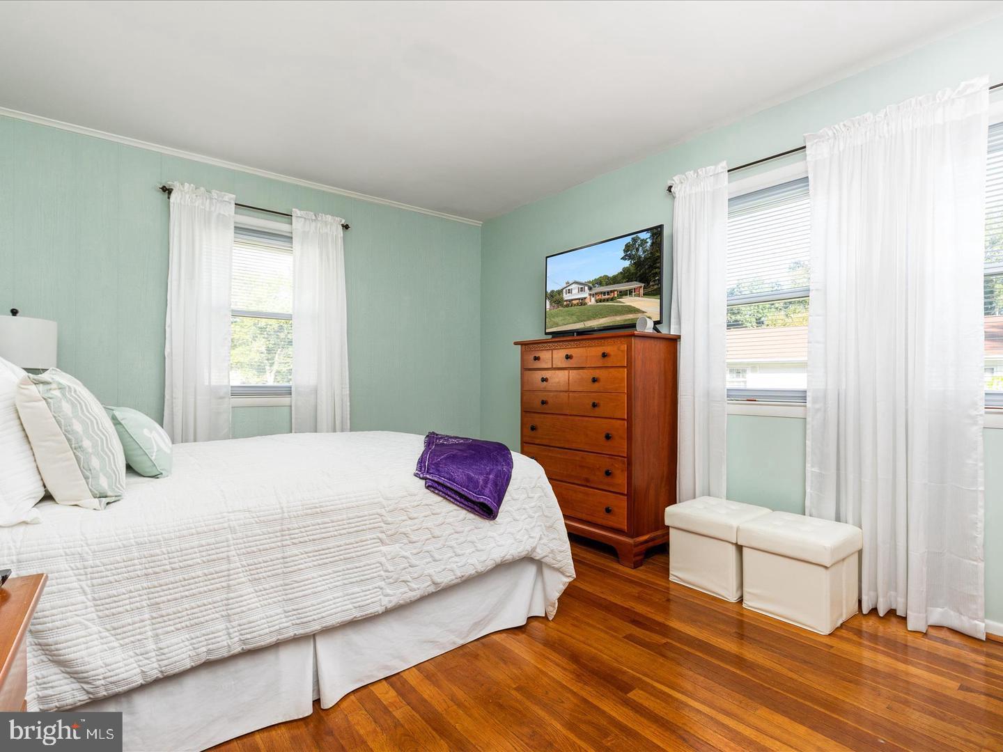 6434 Rives Court Springfield, VA 22150 - Photo 23 of 37 a bedroom with a bed a dresser and a window
