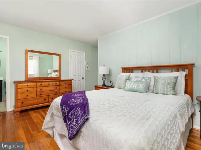 a bedroom with a bed and a dresser in it
