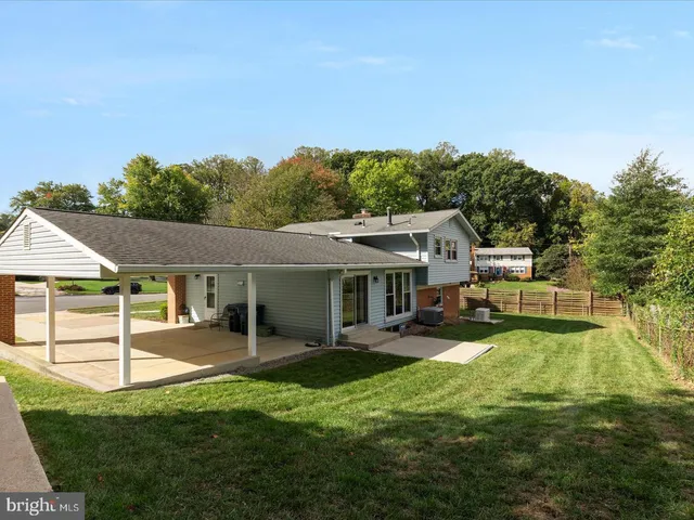 a view of a house with a yard porch and sitting area