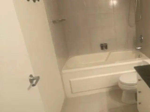 a bathroom with a toilet and a bath tub