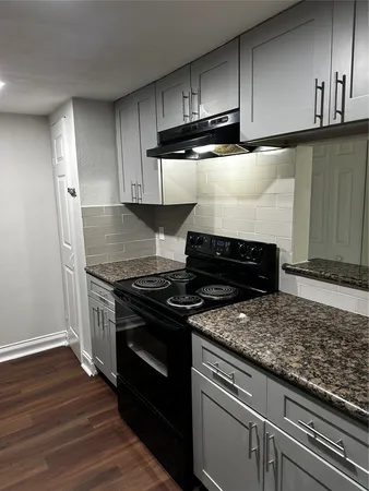 a stove top oven sitting inside of a kitchen