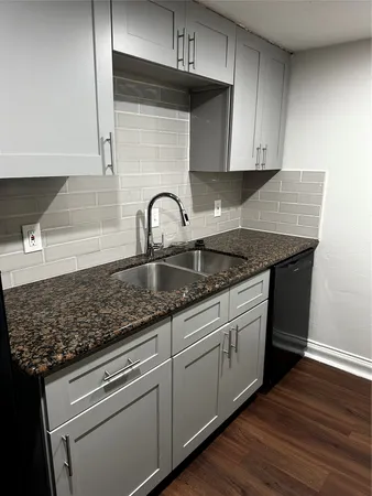 a kitchen with granite countertop white cabinets and a granite counter tops