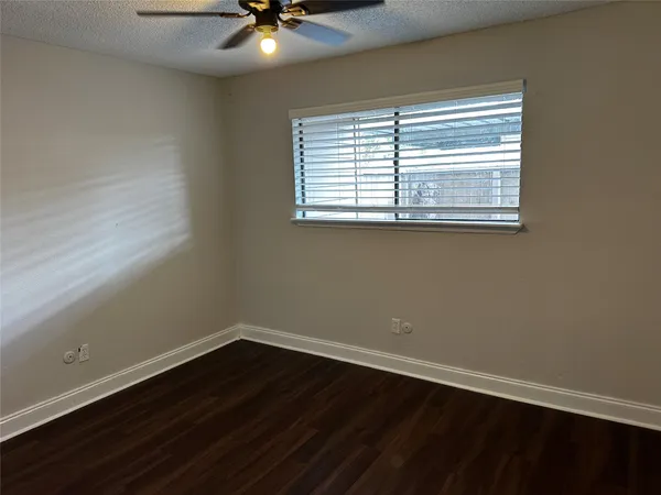 a view of a small space with wooden floor and a window