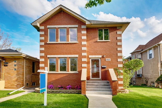 8013 West Irving Park Road Chicago, IL 60634 - Photo 1 of 25 a front view of a house with a yard