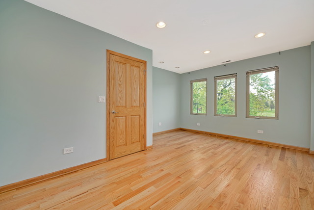 8013 West Irving Park Road Chicago, IL 60634 - Photo 18 of 25 an empty room with wooden floor and windows