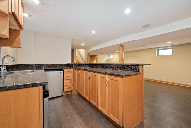 8013 West Irving Park Road Chicago, IL 60634 - Photo 21 of 25 a kitchen with stainless steel appliances granite countertop a sink and a granite counter tops