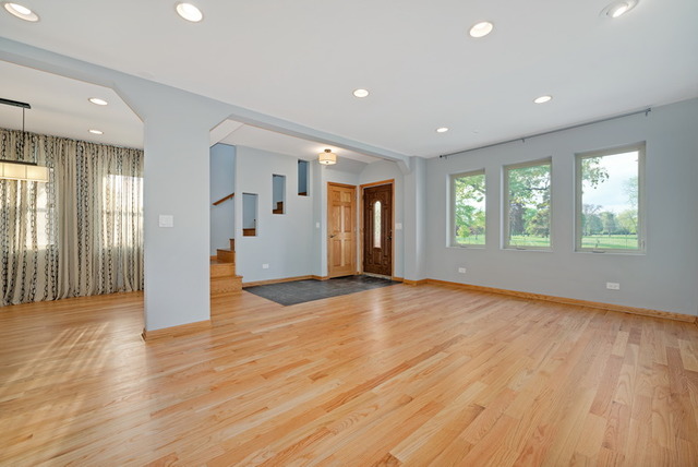 8013 West Irving Park Road Chicago, IL 60634 - Photo 4 of 25 an empty room with wooden floor and windows