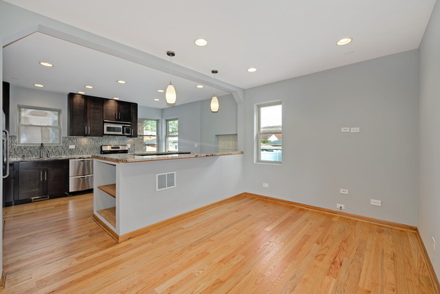 8013 West Irving Park Road Chicago, IL 60634 - Photo 8 of 25 a kitchen with stainless steel appliances a refrigerator a stove top oven and sink