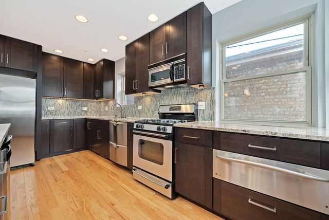 8013 West Irving Park Road Chicago, IL 60634 - Photo 9 of 25 a kitchen with stainless steel appliances granite countertop a stove a sink and a refrigerator