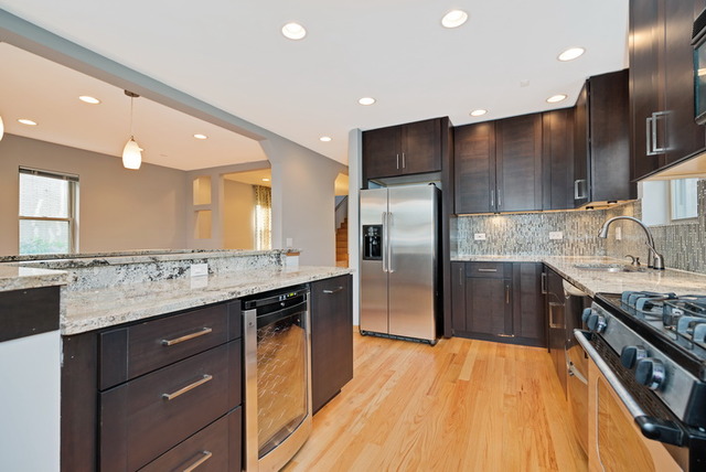 8013 West Irving Park Road Chicago, IL 60634 - Photo 10 of 25 a kitchen with stainless steel appliances granite countertop a sink a stove and a refrigerator