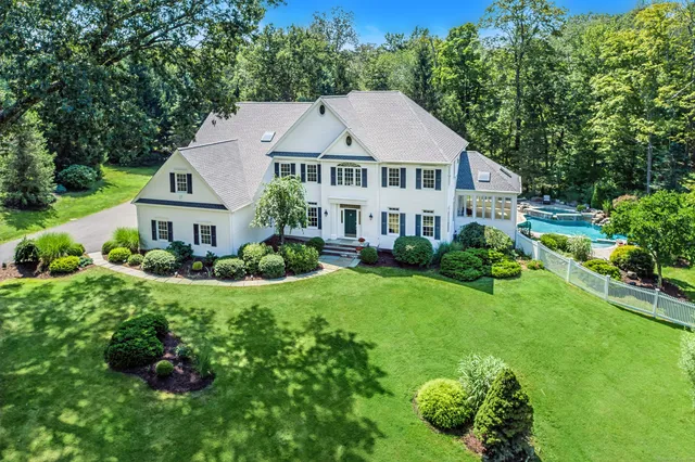 a house with a big yard and large trees