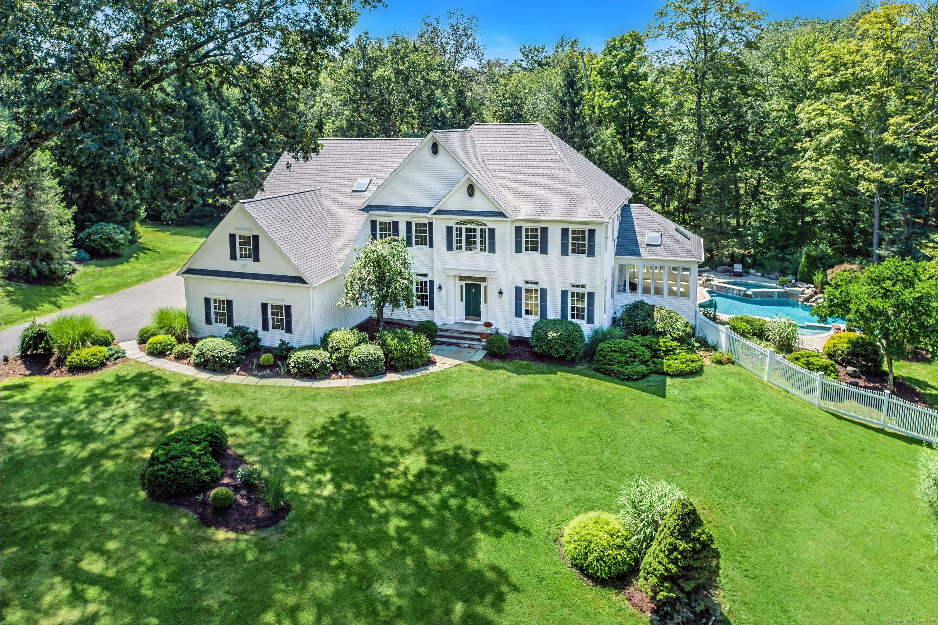 a house with a big yard and large trees