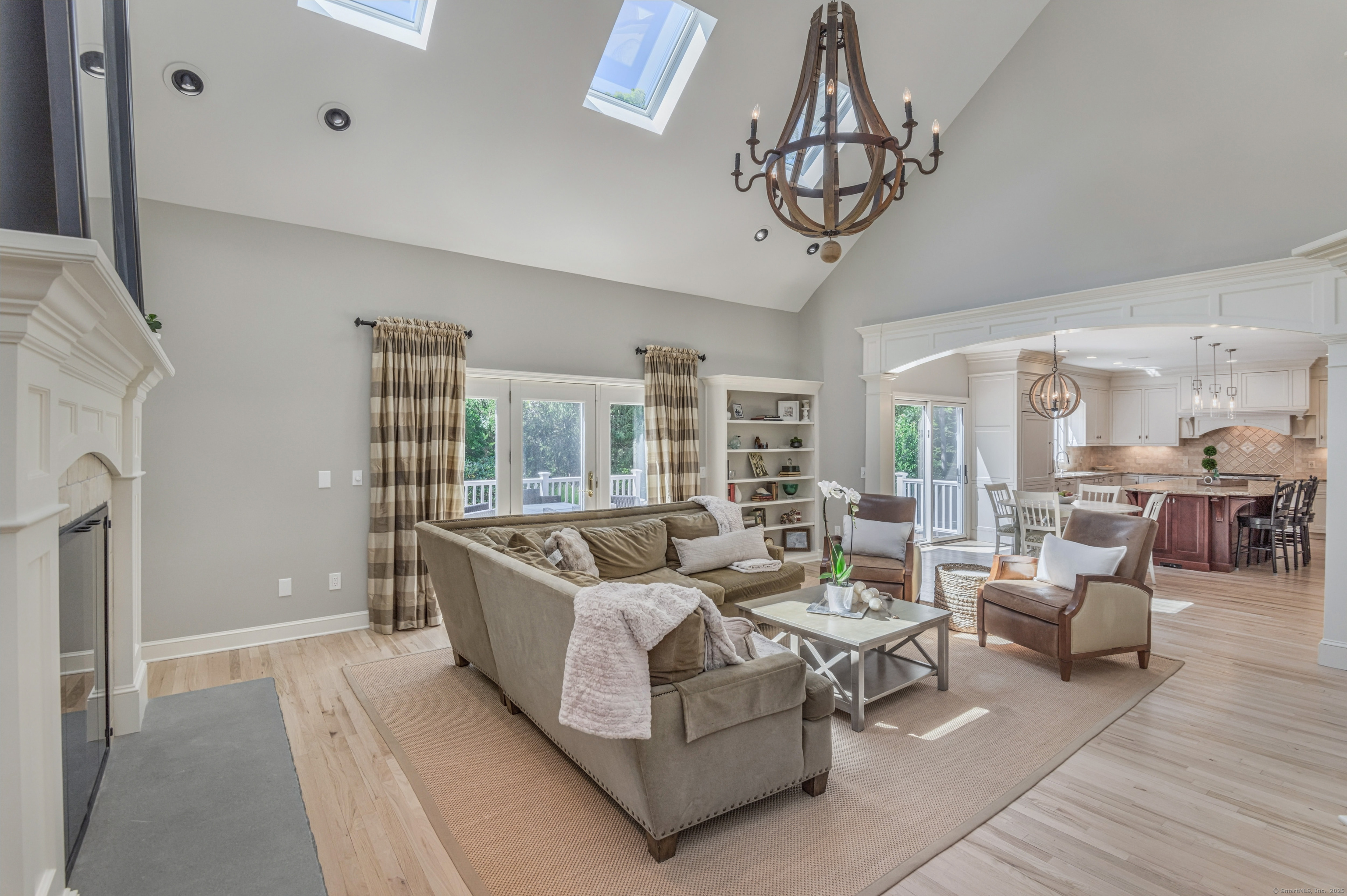 21 Schoolhouse Place Ridgefield, CT 06877 - Photo 14 of 40 a living room with furniture a chandelier a rug and a window