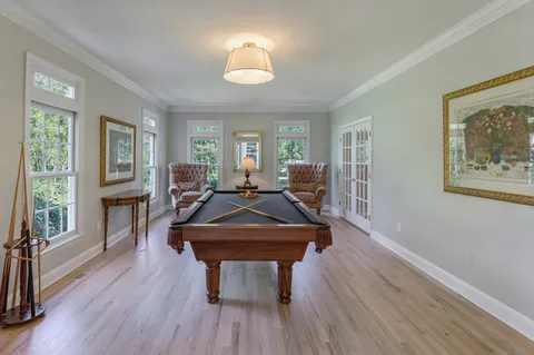 a living room with furniture a window and wooden floor