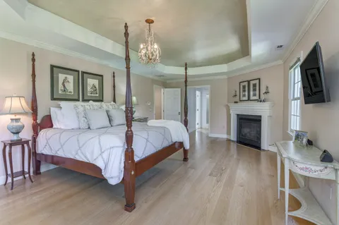 a spacious bedroom with a bed and a flat screen tv