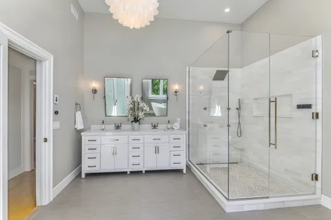 a bathroom with a shower sink and mirror