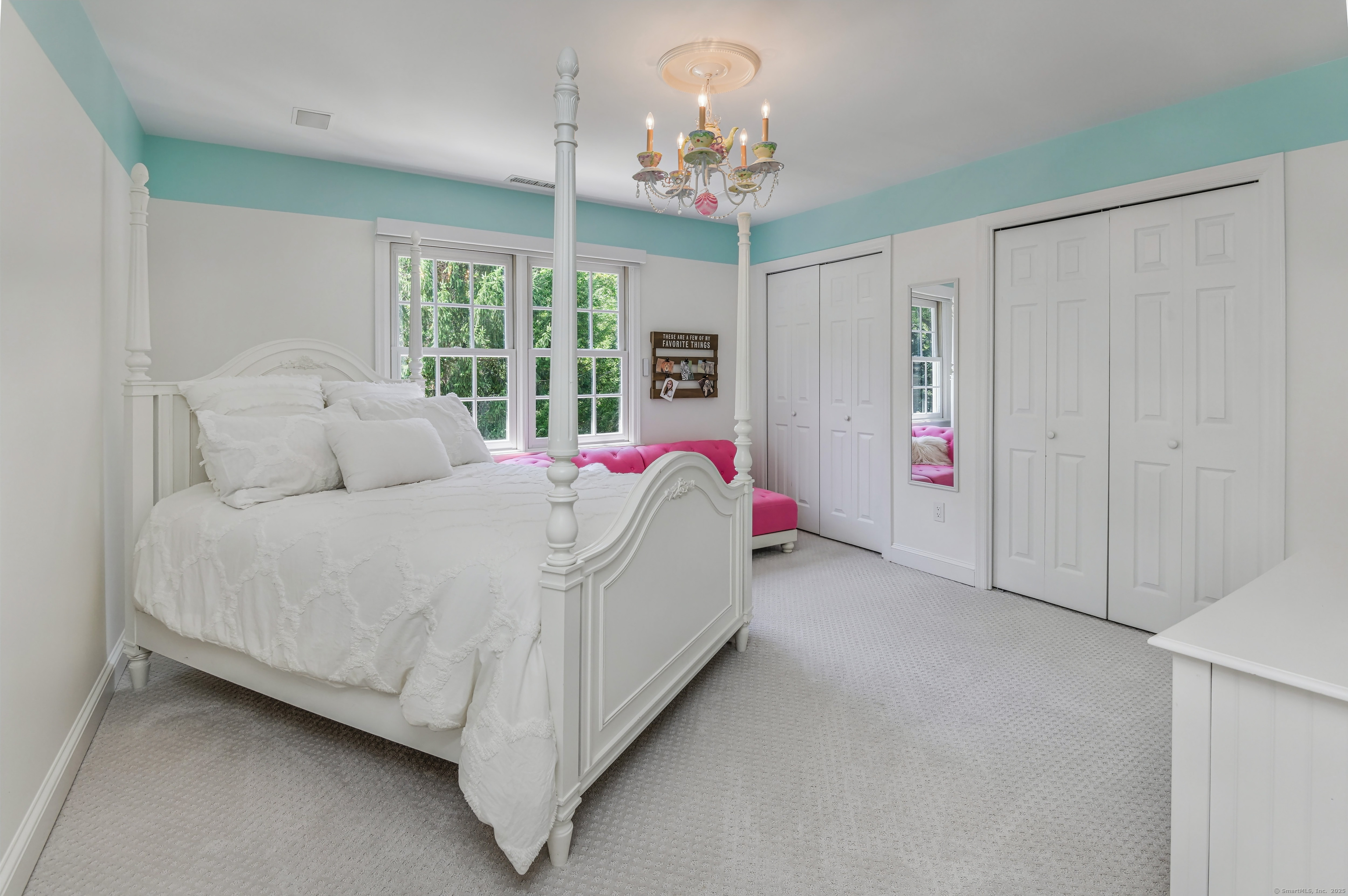 21 Schoolhouse Place Ridgefield, CT 06877 - Photo 23 of 40 a bed room with a bed and a chandelier