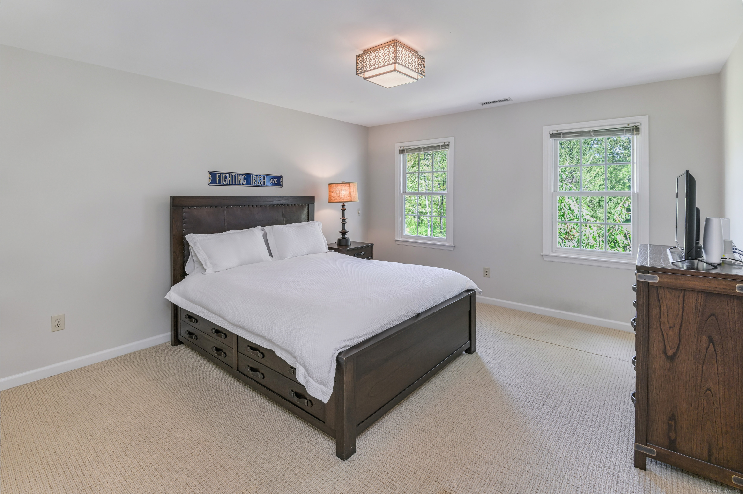 21 Schoolhouse Place Ridgefield, CT 06877 - Photo 24 of 40 a bed sitting in a bedroom next to a window