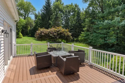 a view of a deck with wooden floor and barbeque oven
