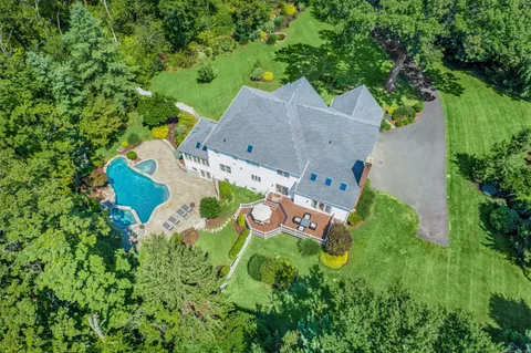 an aerial view of house with yard swimming pool and outdoor seating